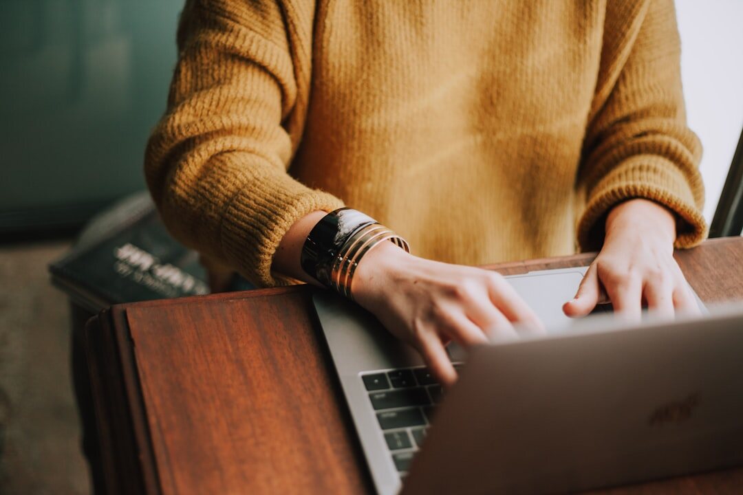 author typing on laptop